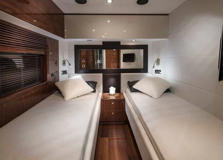 a room with a bed and a television aboard PALUMBA Yacht for Sale