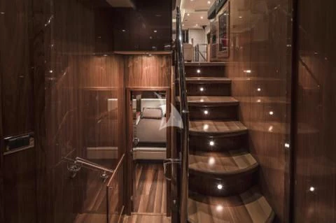a room with wooden walls and a wood door aboard PALUMBA Yacht for Sale