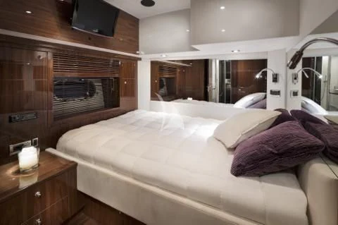 a bed with a white sheet aboard PALUMBA Yacht for Sale
