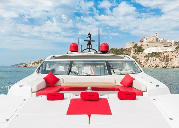 a white car with red doors on a boat on a body of water aboard PALUMBA Yacht for Sale