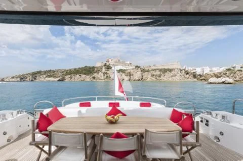 a table with chairs on it by a body of water aboard PALUMBA Yacht for Sale