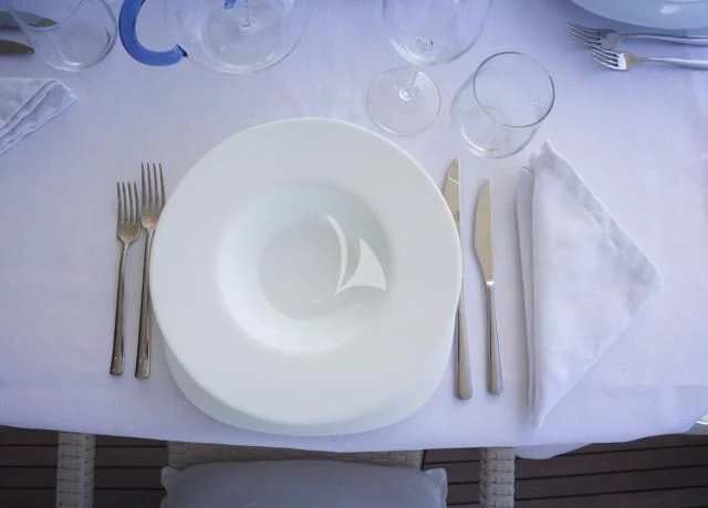 a plate with silverware on it aboard LADY A Yacht for Charter
