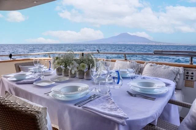 a table set for a dinner aboard LADY A Yacht for Charter