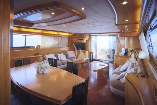a large living room with a large table and chairs aboard LADY A Yacht for Charter