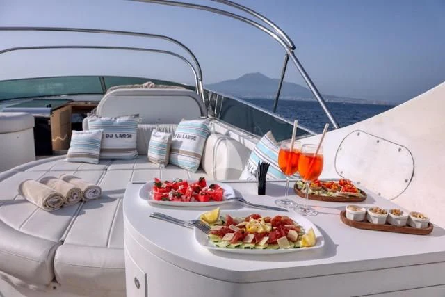 a table with food and drinks on it aboard LADY A Yacht for Charter