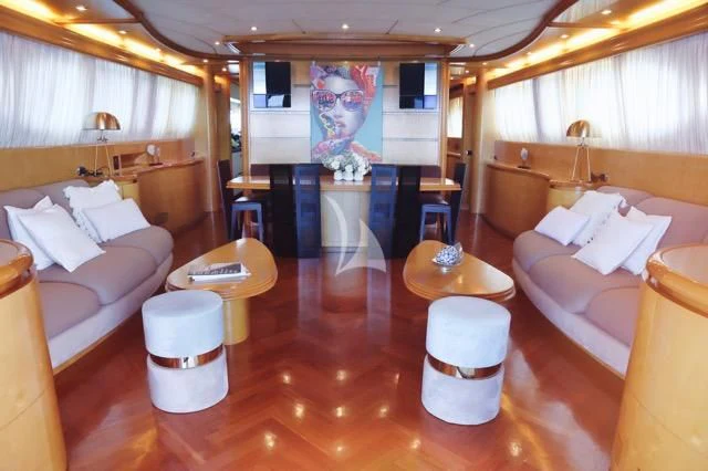 a room with a table chairs and a couch aboard LADY A Yacht for Charter