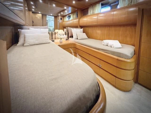 a room with a bed and a desk aboard LADY A Yacht for Charter