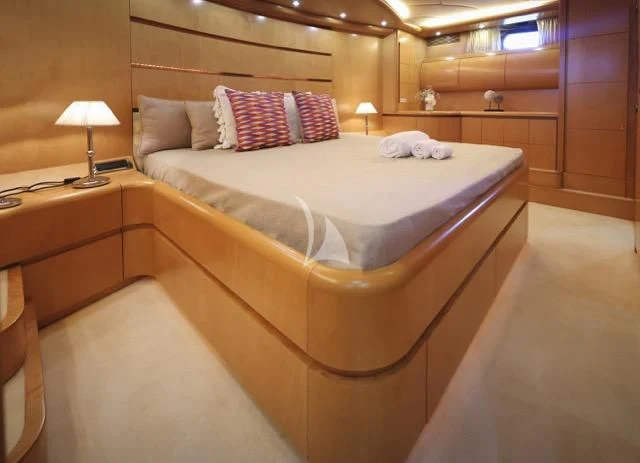 a room with a bed and a lamp aboard LADY A Yacht for Charter