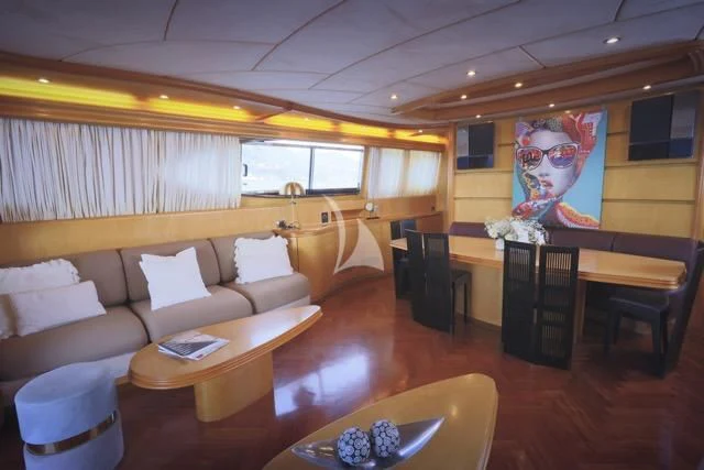 a living room with a couch and a table aboard LADY A Yacht for Charter