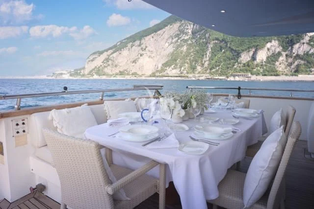 a table set for a meal on a boat aboard LADY A Yacht for Charter
