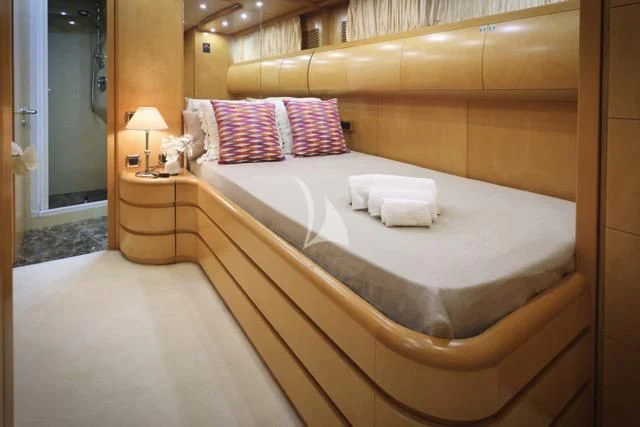 a bed with a white sheet aboard LADY A Yacht for Charter
