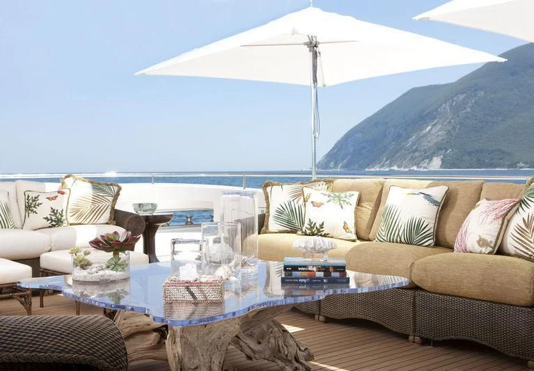 a living room with a large white umbrella aboard KOLAHA Yacht for Sale
