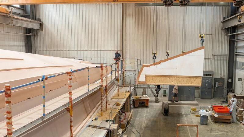 a large factory with several people working aboard HEAVY ACTION Yacht for Sale
