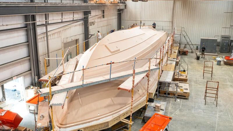 a large white boat in a warehouse aboard HEAVY ACTION Yacht for Sale