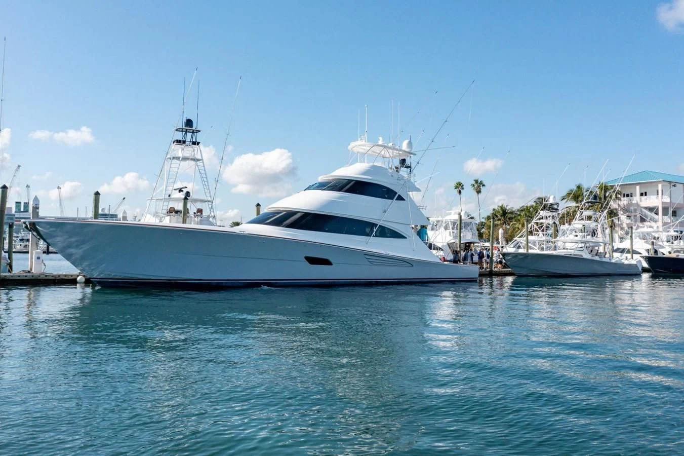 a white yacht in a harbor aboard HEAVY ACTION Yacht for Sale
