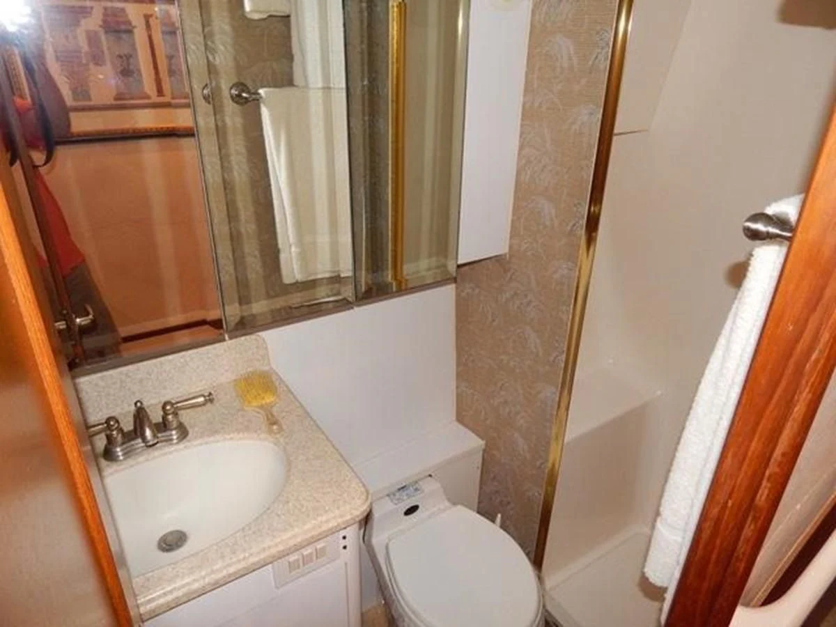 a bathroom with a sink toilet and a bathtub aboard ONE MORE TIME Yacht for Sale