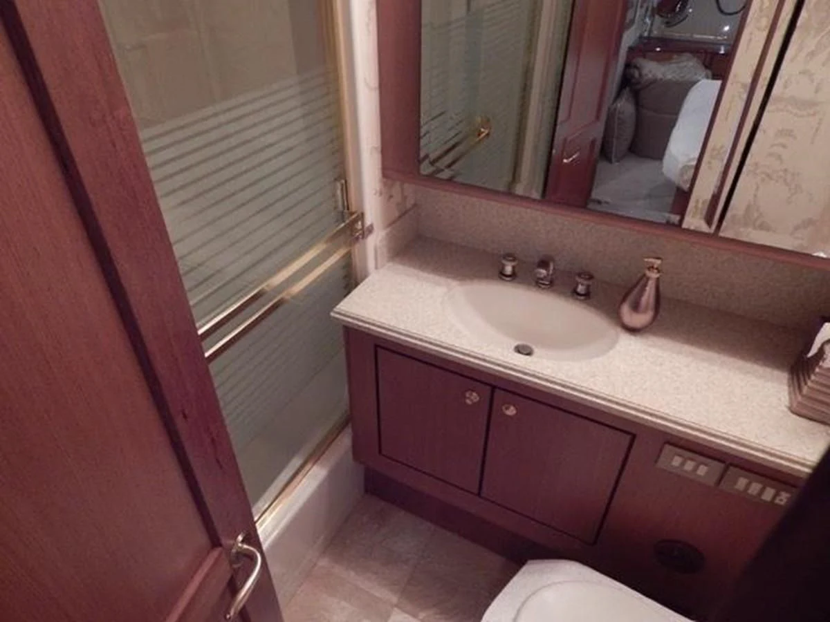 a bathroom with a sink and a mirror aboard ONE MORE TIME Yacht for Sale