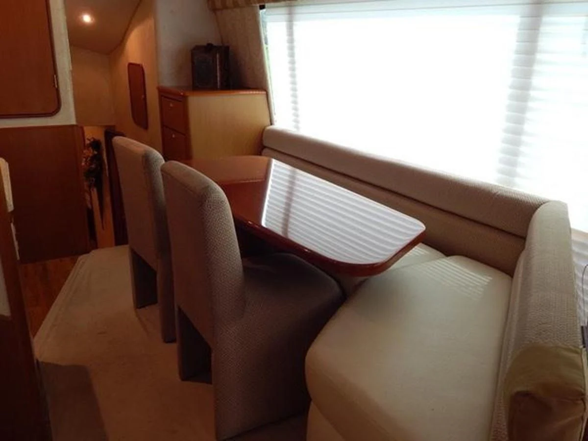 a room with a window and chairs aboard ONE MORE TIME Yacht for Sale