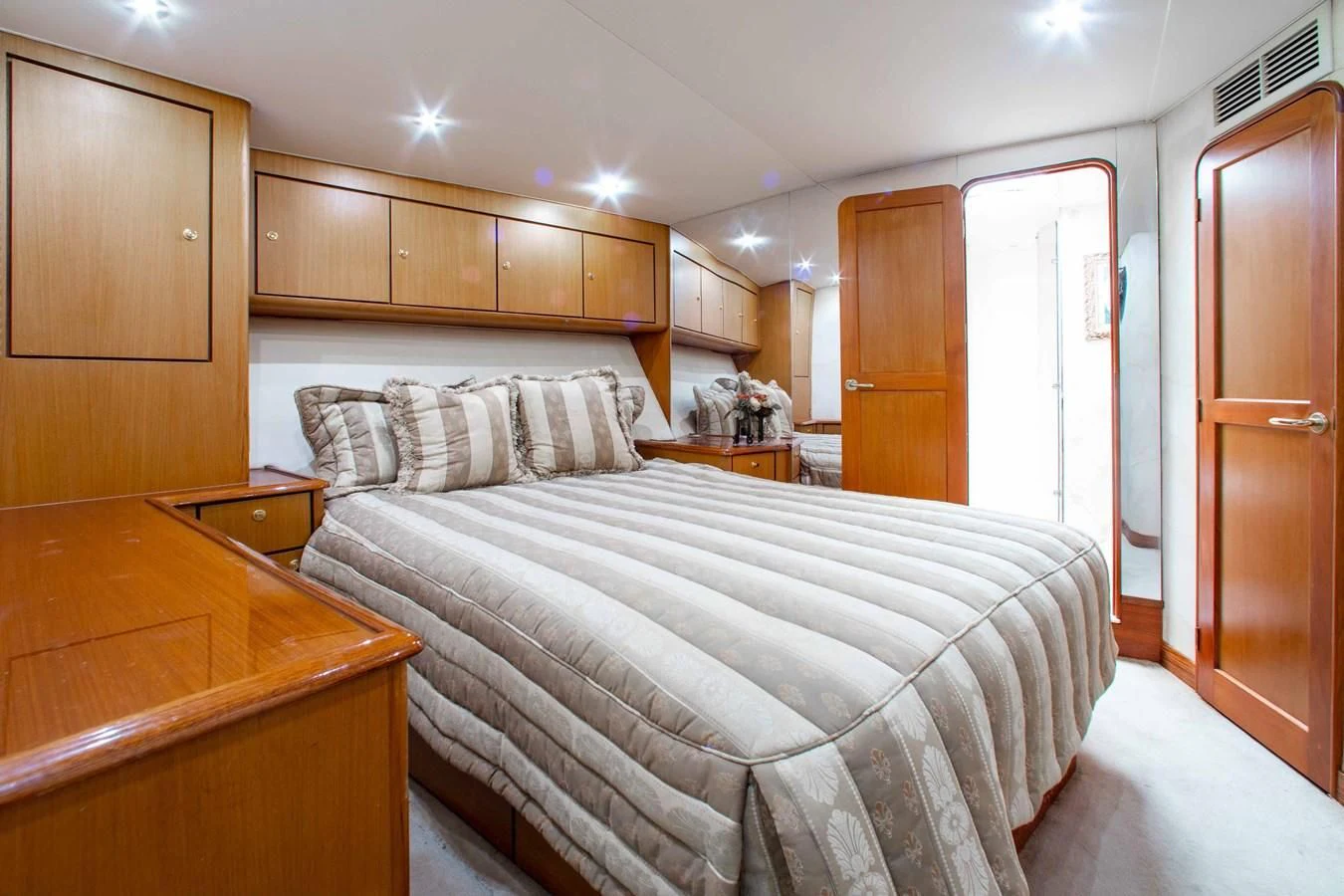 a bedroom with a bed and a desk aboard ONE MORE TIME Yacht for Sale