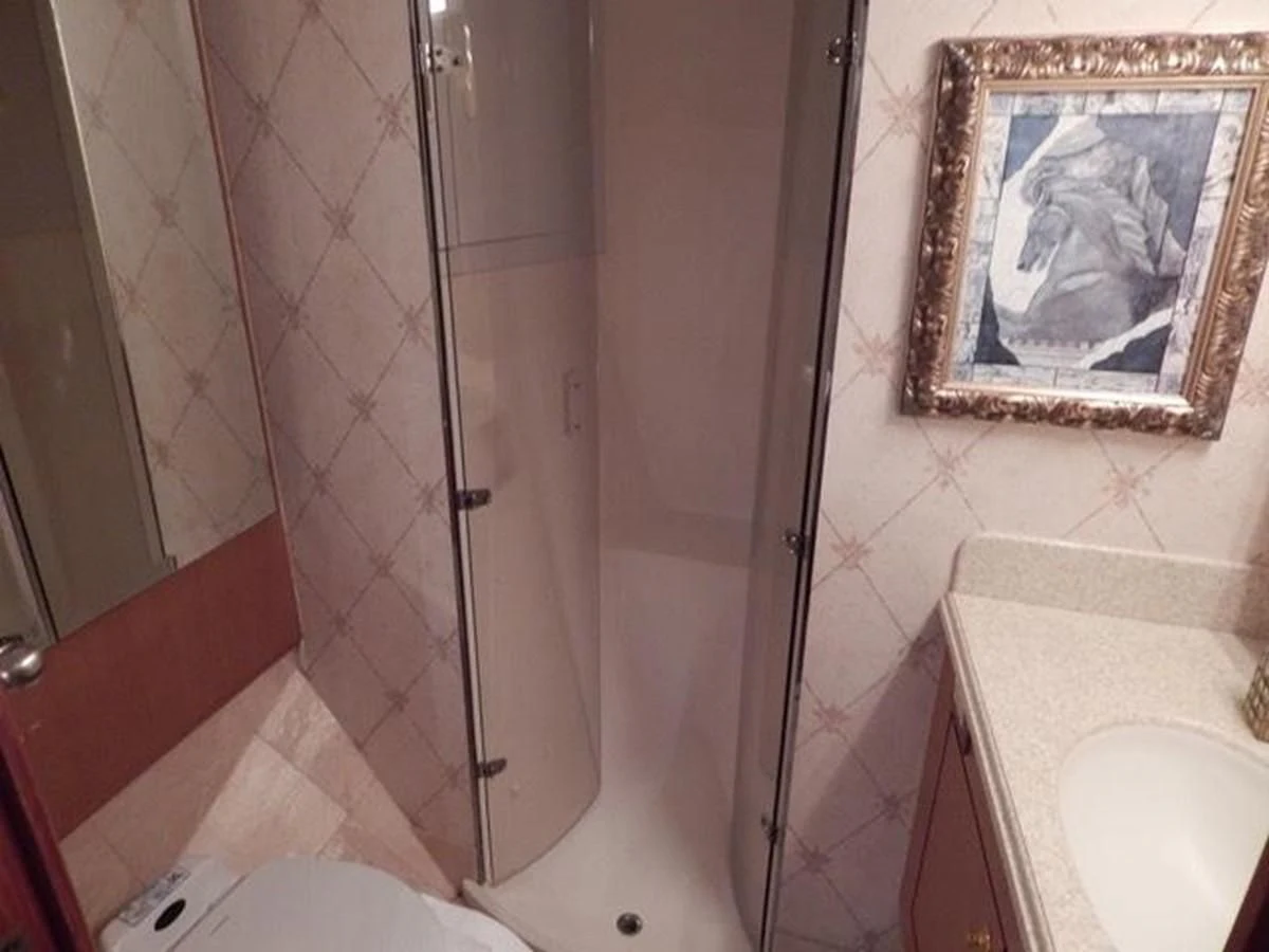 a bathroom with a bathtub and sink aboard ONE MORE TIME Yacht for Sale