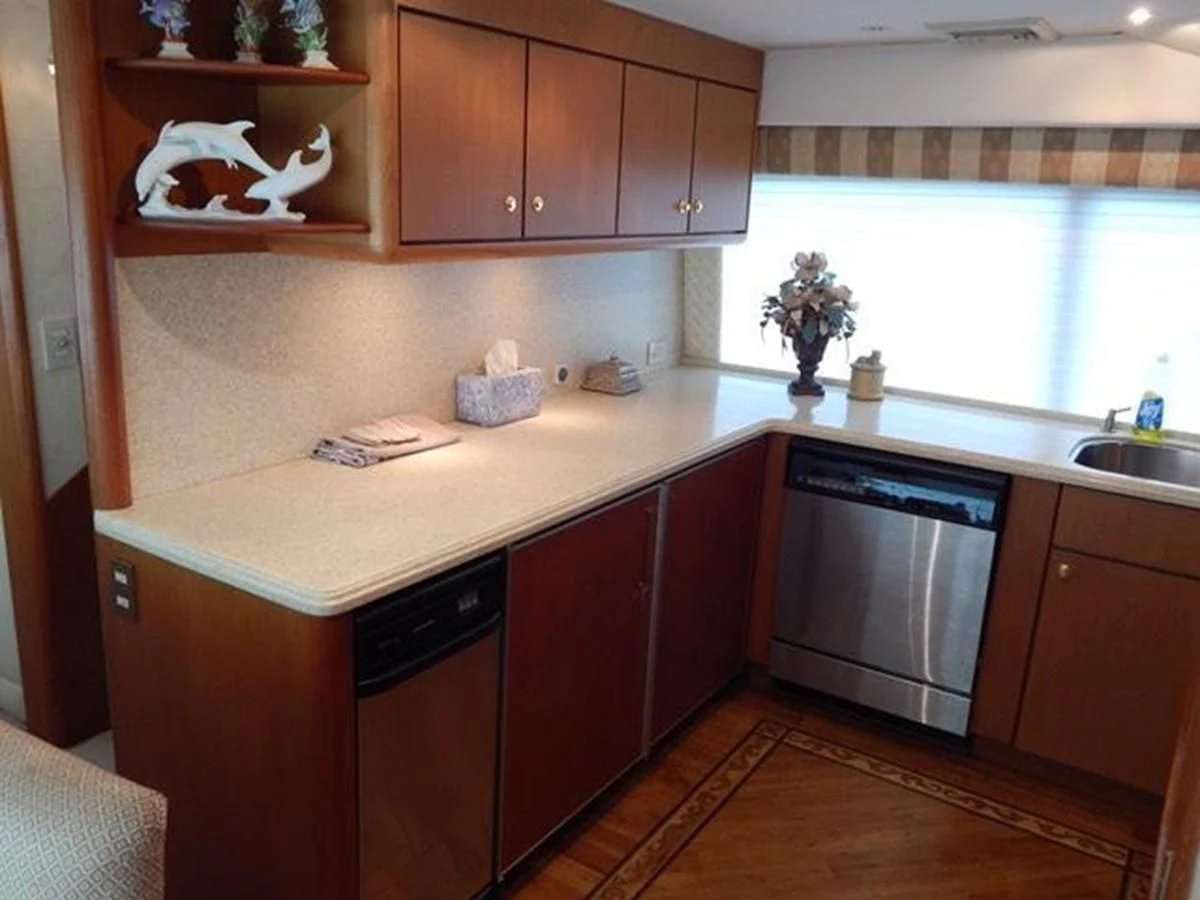 a kitchen with wooden cabinets aboard ONE MORE TIME Yacht for Sale