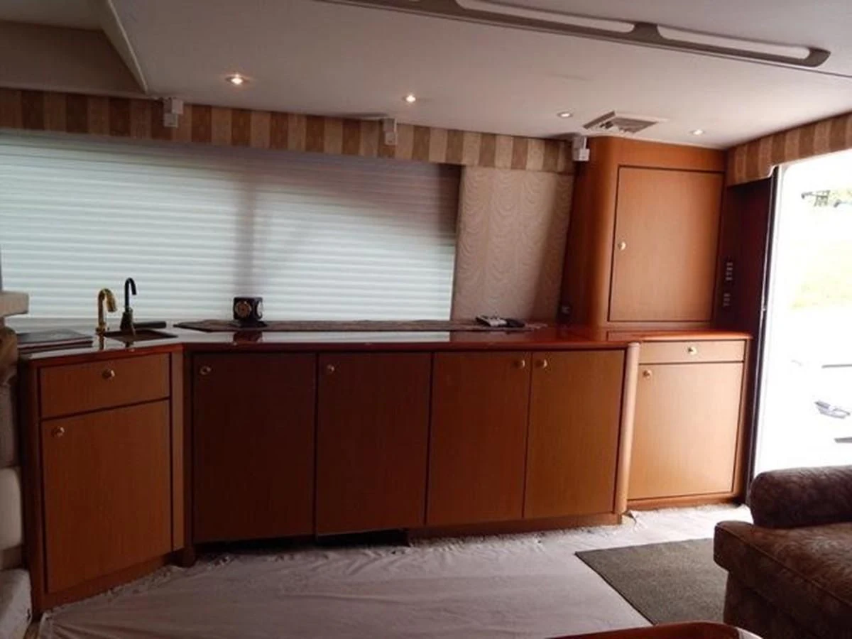 a kitchen with wooden cabinets aboard ONE MORE TIME Yacht for Sale