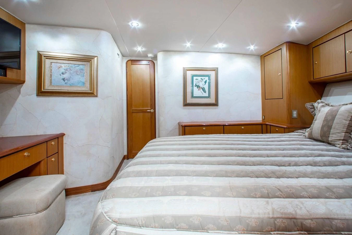 a bedroom with a bed and a chair aboard ONE MORE TIME Yacht for Sale
