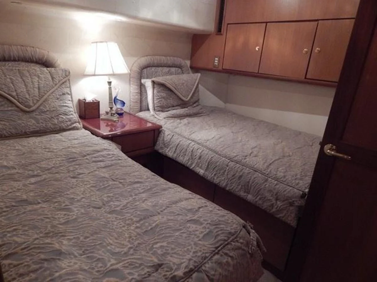 a bed with a lamp on it aboard ONE MORE TIME Yacht for Sale