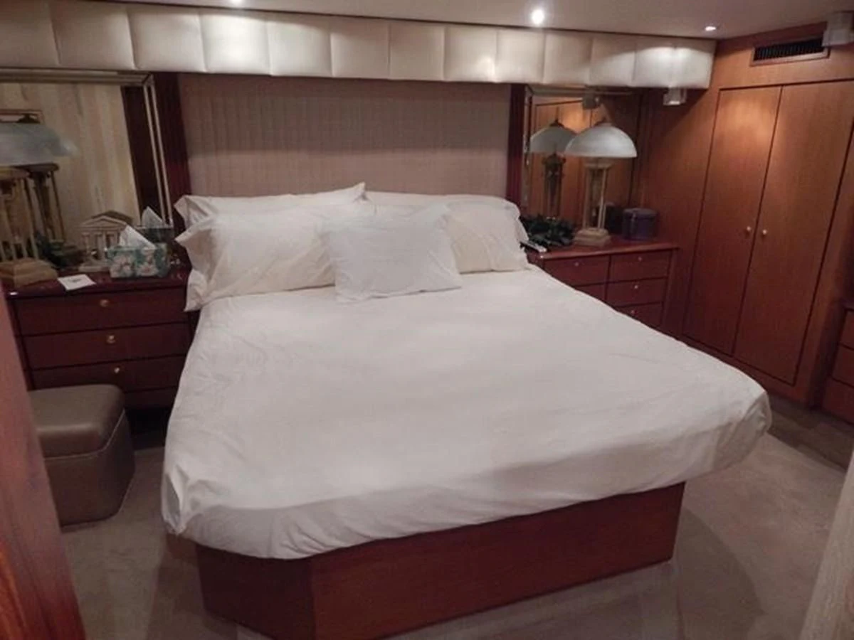 a bed with white sheets aboard ONE MORE TIME Yacht for Sale