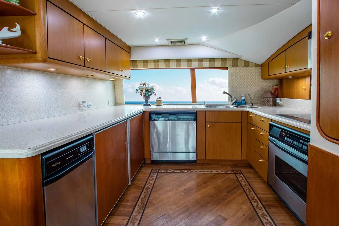 a kitchen with wooden cabinets aboard ONE MORE TIME Yacht for Sale