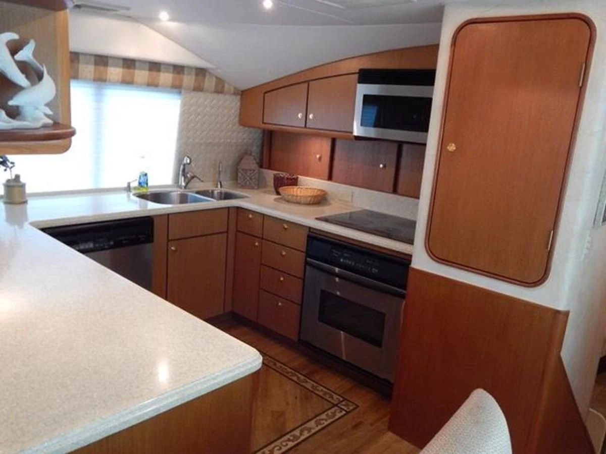 a kitchen with wooden cabinets aboard ONE MORE TIME Yacht for Sale