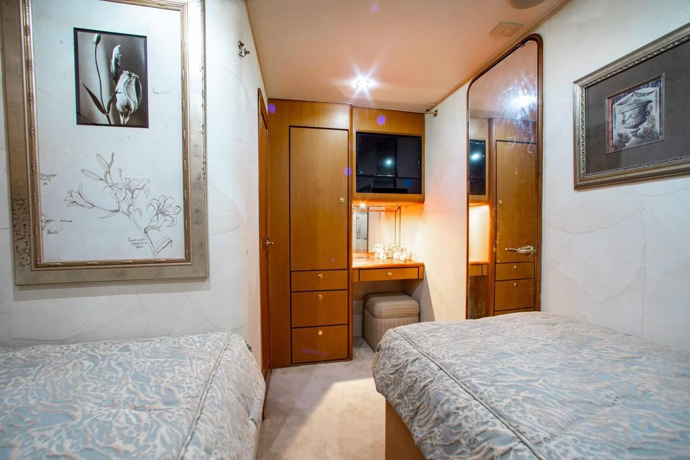 a bedroom with a bed and a tv on the wall aboard ONE MORE TIME Yacht for Sale