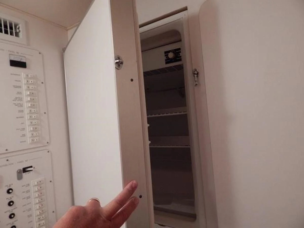 a person opening a door aboard ONE MORE TIME Yacht for Sale