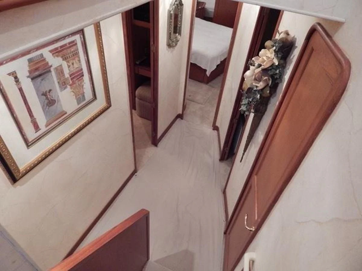 a hallway with a door and a chair and a table aboard ONE MORE TIME Yacht for Sale