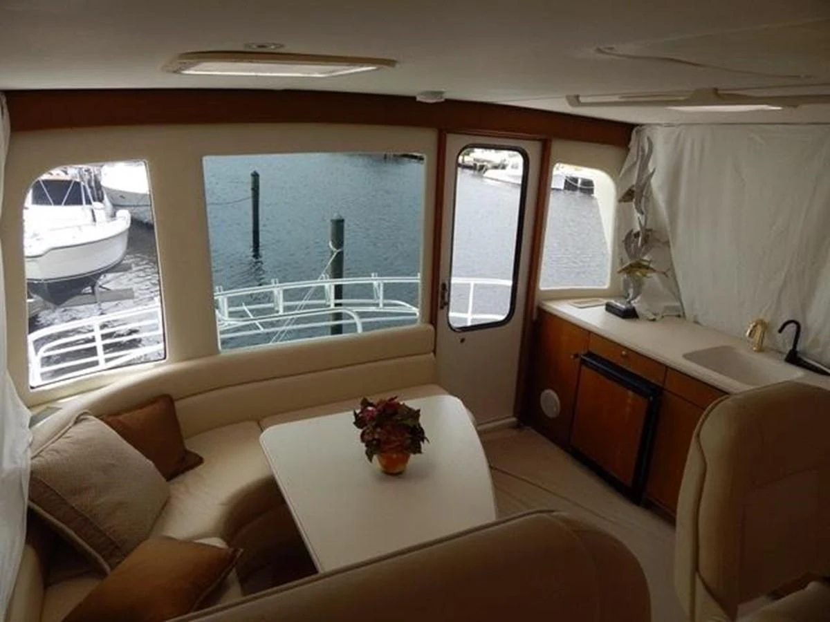 a room with a table and chairs aboard ONE MORE TIME Yacht for Sale