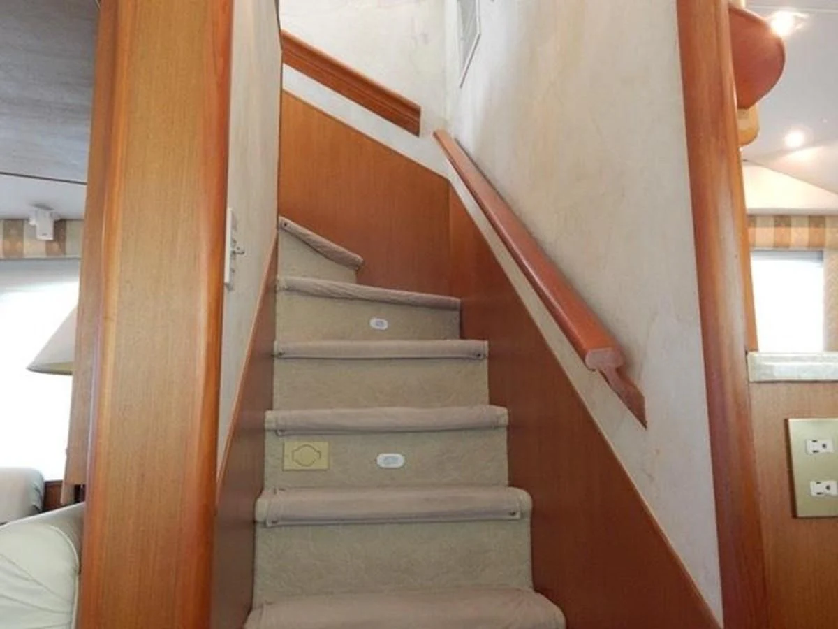 a staircase with a wood railing aboard ONE MORE TIME Yacht for Sale