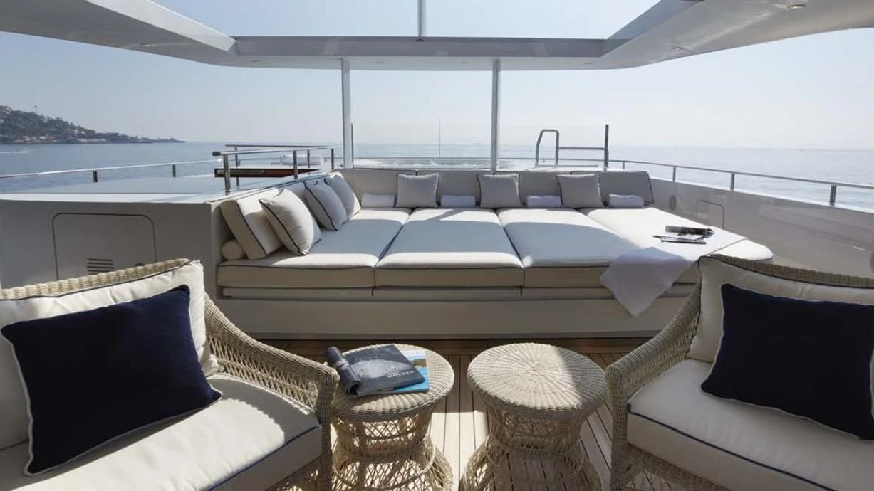 a large white yacht with a couch and a table aboard FORWIN Yacht for Sale