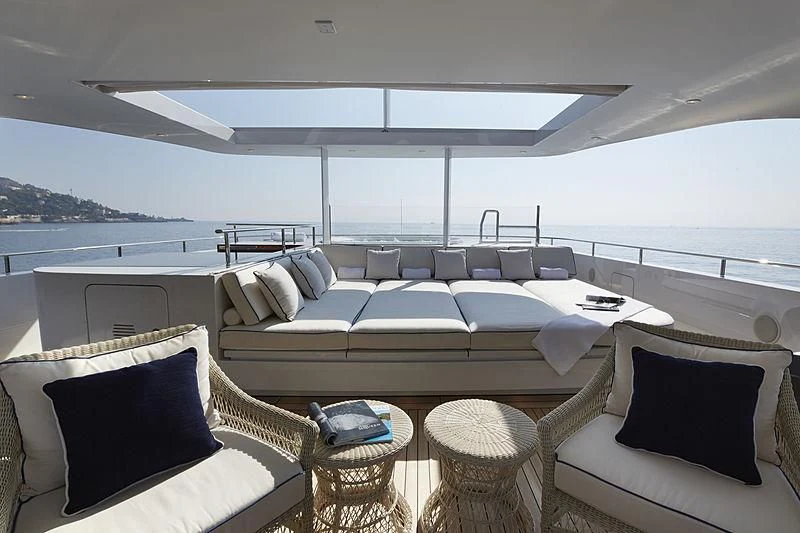 a large white lounge chair in a room with a large white bed and a large white sofa and aboard FORWIN Yacht for Sale