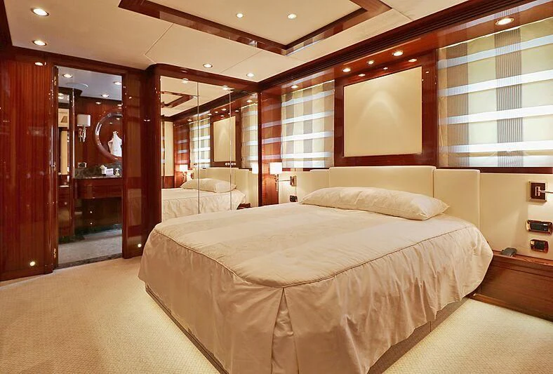 a room with a bed and a mirror aboard FORWIN Yacht for Sale
