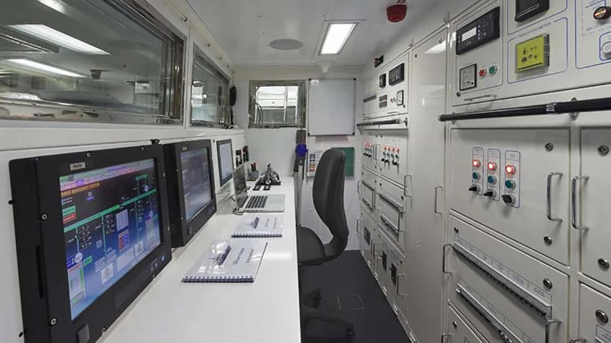 a room with computers and monitors aboard FORWIN Yacht for Sale