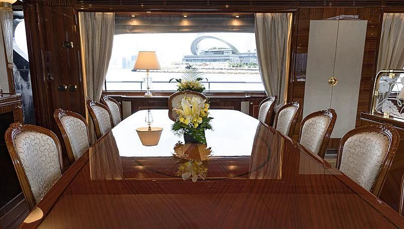 a dining table with chairs and a window aboard FORWIN Yacht for Sale