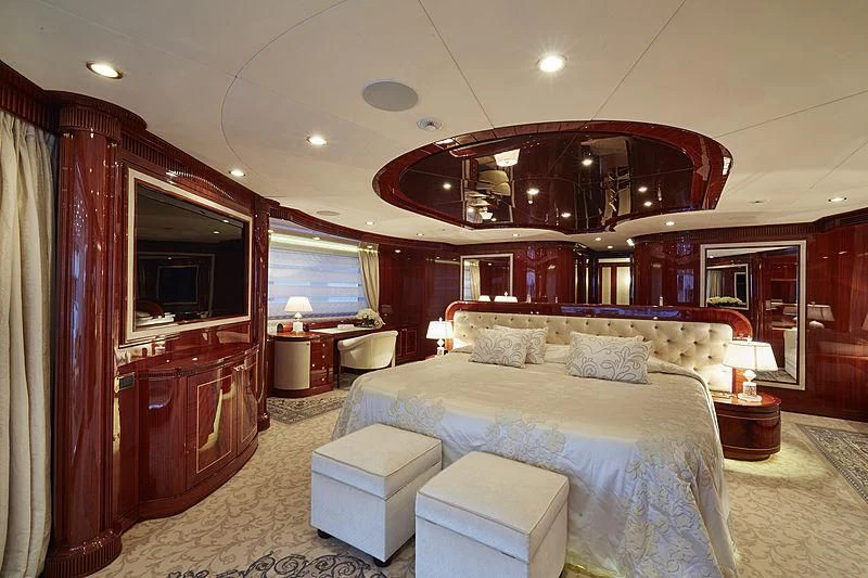a bedroom with a bed and a mirror aboard FORWIN Yacht for Sale