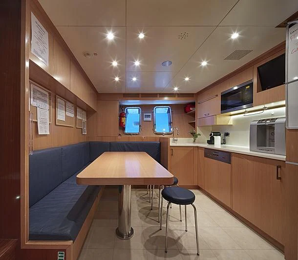 a room with a table and chairs aboard FORWIN Yacht for Sale