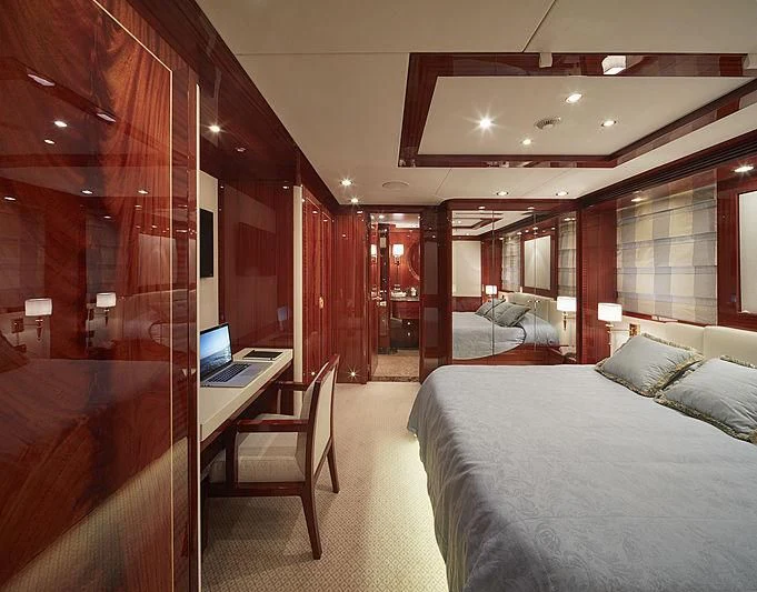 a room with a bed and desk aboard FORWIN Yacht for Sale