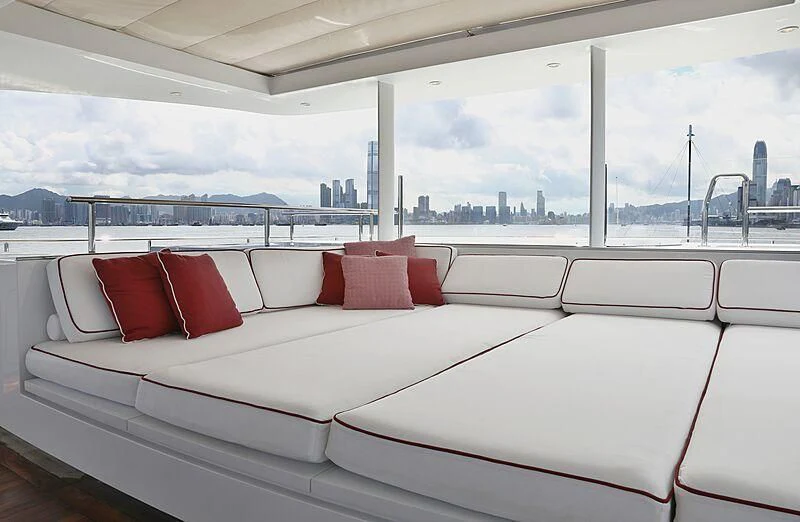 a white couch with red pillows aboard FORWIN Yacht for Sale