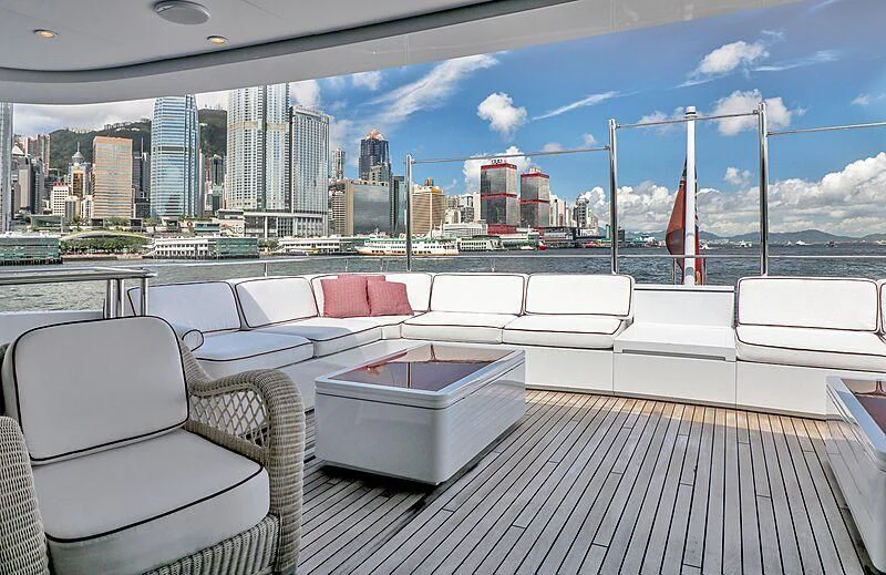 a deck with a view of a city and a body of water aboard FORWIN Yacht for Sale