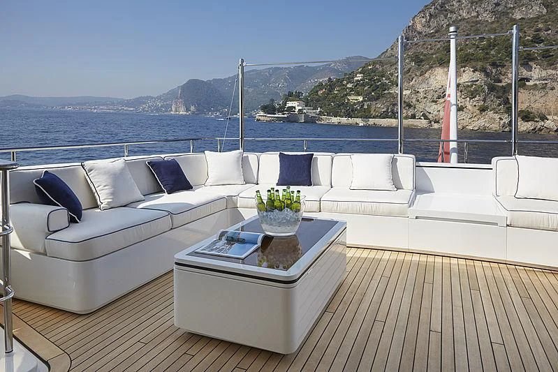 a white couch on a deck overlooking a body of water aboard FORWIN Yacht for Sale