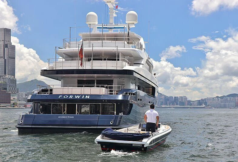 a large boat with a person standing on the deck aboard FORWIN Yacht for Sale