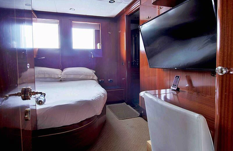 a room with a bed and a chair aboard FORWIN Yacht for Sale