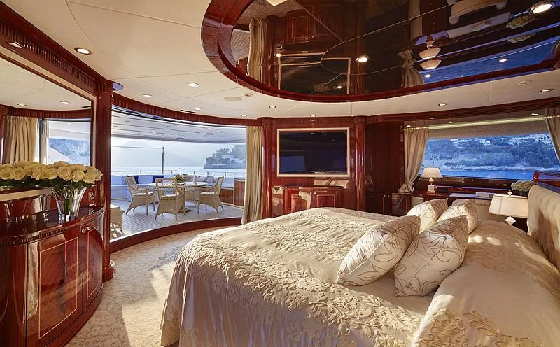 a room with a bed and a large window aboard FORWIN Yacht for Sale